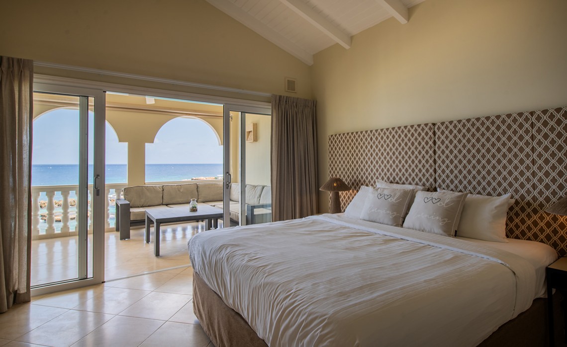 master bedroom with sea view in the marvelous three bedroom penthouse apartment named Dolphin Paradise by Curacao Luxury Holiday Rentals